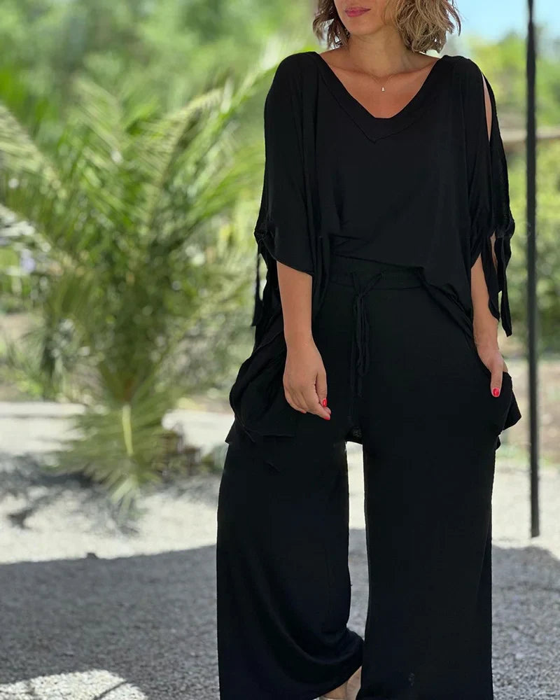 Brīvā divdaļīga kostīma ar plašām biksēm